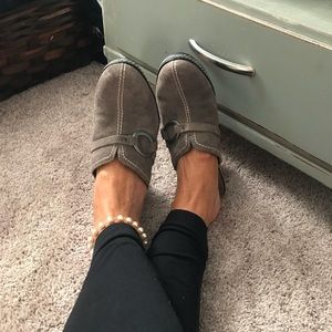 Fashionable versatile gray suede wedge heel clogs.